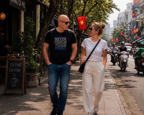 Saigon With Me travel companion walking with a visitor in a hidden alley of Ho Chi Minh City.