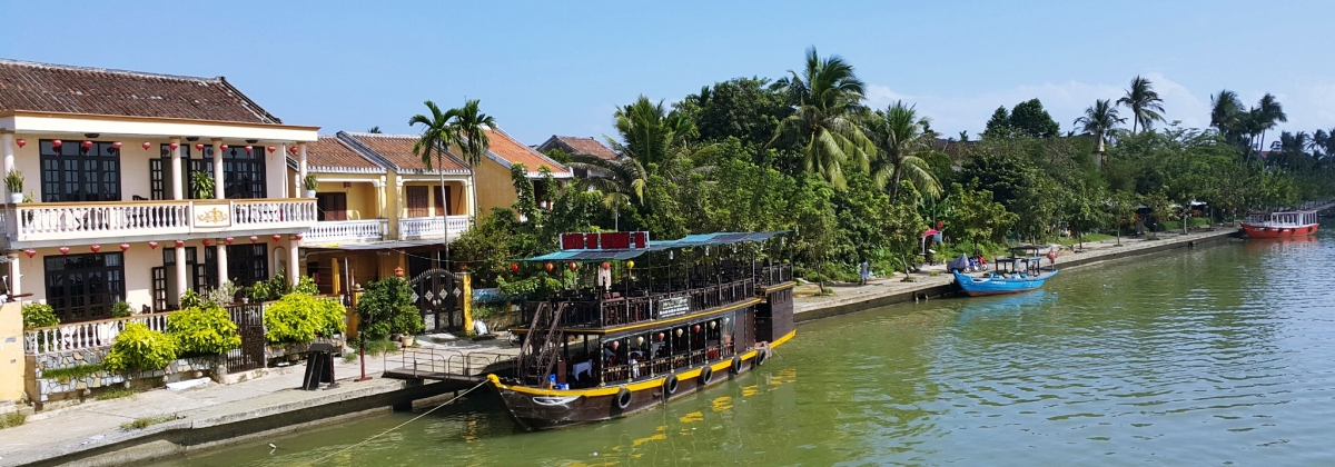 Hoi An riverside with traditional boats and historic houses in central Vietnam