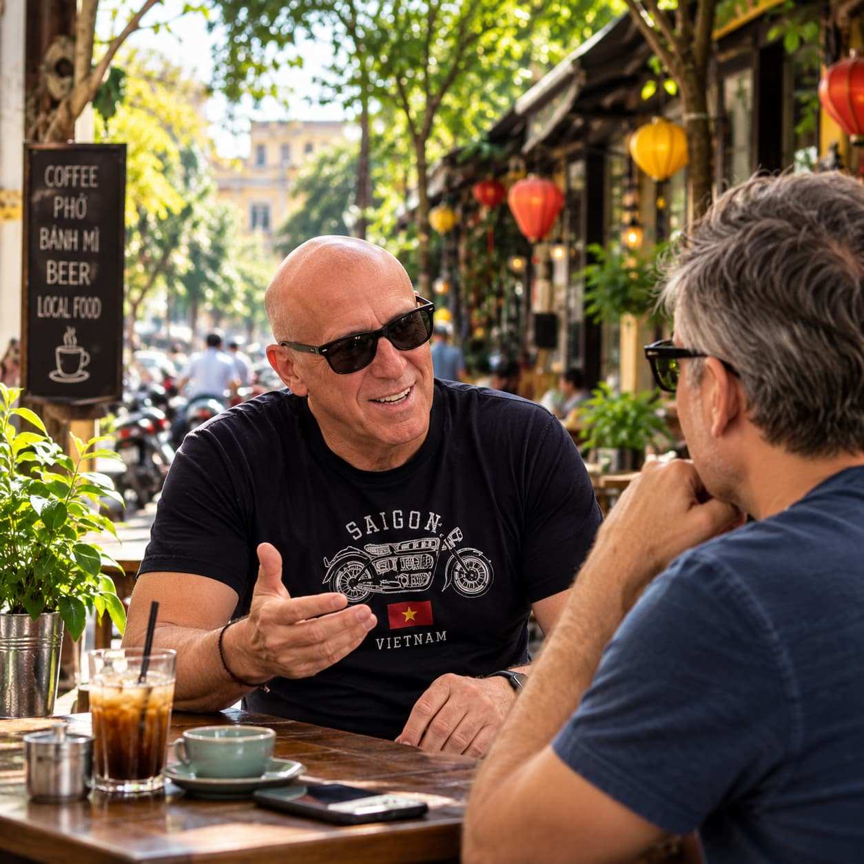 Two people talking at an outdoor café in Saigon